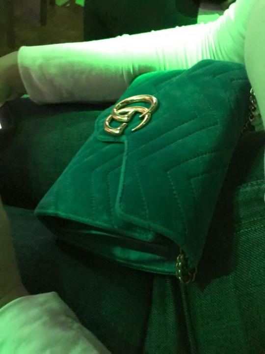 Teal woman’s Gucci purse gold straps